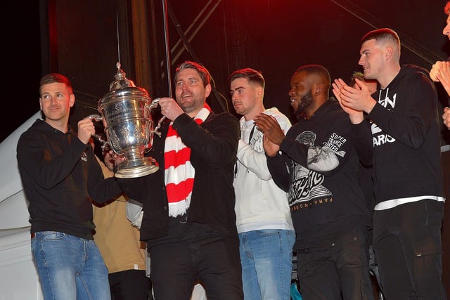 Derry City captain Patrick McEleney and manager Ruaidhrí Higgins with the FAI Cup in Guildhall Square on Monday night during the homecoming celebrations. Photo: George Sweeney.  DER2244GS – 047