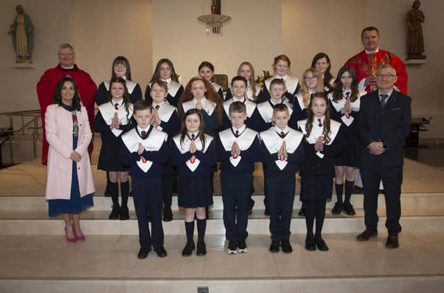 Children from Holy Child PS, Creggan who received the Sacrament of Confirmation from Fr. Daniel McFaul at St. Mary’s Church, on Friday afternoon last. Included from left are Mrs. Pat Concannon, Principal, Fr. Ignacy, and on right, Mr Liam O'Faolain, teacher. (Photo: Jim McCafferty Photography)