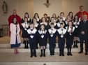 Children from Holy Child PS, Creggan who received the Sacrament of Confirmation from Fr. Daniel McFaul at St. Mary’s Church, on Friday afternoon last. Included from left are Mrs. Pat Concannon, Principal, Fr. Ignacy, and on right, Mr Liam O'Faolain, teacher. (Photo: Jim McCafferty Photography)