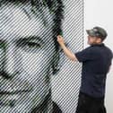 Artist Joe Black adds the finishing touches to a portrait of David Bowie made from over 8,500 guitar plectrums, commissioned by Sky Arts to celebrate Bowie topping a new definitive list of Britain's 50 most influential artists of the past 50 years