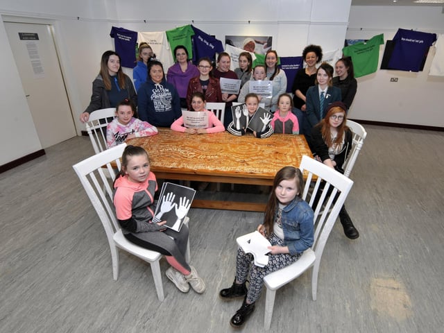 Pictured at ‘Talking Chairs’ installation, unveiled in the Eden Place Arts Centre at Pilot’s Row Community Centre on International Women’s Day, are members of St Mary's Youth Club, Headliners and The Rainbow Project who etched their words from their ‘normalised sexism’ project into the chairs. DER1017GS013