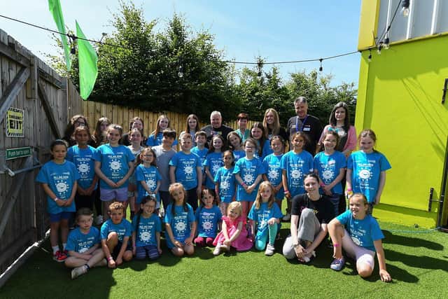 Some of the two hundred children and young people from across the community who participated in the week long Good Relations, arts based, Summer Camps held at Studio. Included in the photograph are Ollie Green and Gareth McAlinden from Studio 2 and Geraldine Dougan from Radius Housing Association who supported the programme. Photo: George Sweeney