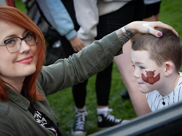 This young man gets some very intricate face painting.