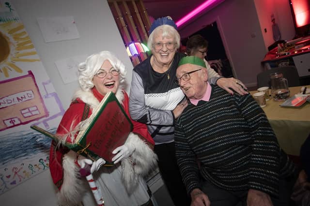 Mrs. Claus gets the group started on some Christmas Carols.
