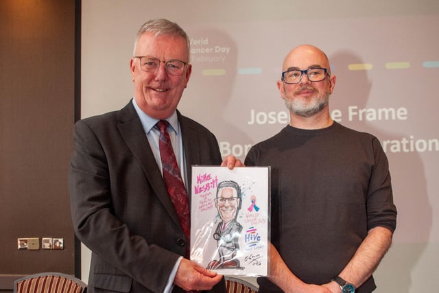 Local artist Barry McGowan presenting a portrait to the Health Minister.