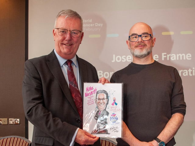 Local artist Barry McGowan presenting a portrait to the Health Minister.