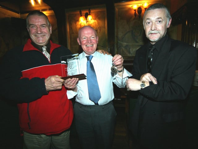 Martin Mc Elhinney being presented with retirement gifts from work colleagues, Joe Stevenson and Danny Mc Cartney 0151JML : Parties and celebrations January 2006: Martin McElhinney.