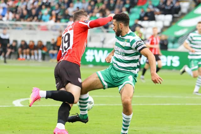 Derry City winger Ryan Graydon is caught by Shamrock Rovers defender Roperto Lopes in the first half at Tallaght. Photographs by Kevin Moore.