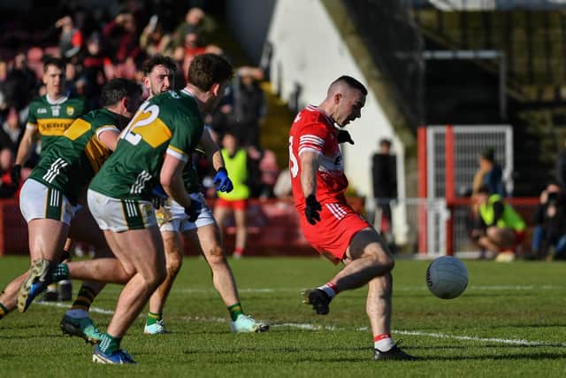 Derry’s Niall Toner gets of a shot as Kerry players close in. Photo: George Sweeney