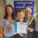 Seanán pictured sharing his successes with Rotary President, Dr. Morris Brown and his parents, Damian and Patricia Gallagher