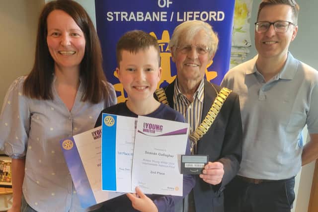 Seanán pictured sharing his successes with Rotary President, Dr. Morris Brown and his parents, Damian and Patricia Gallagher