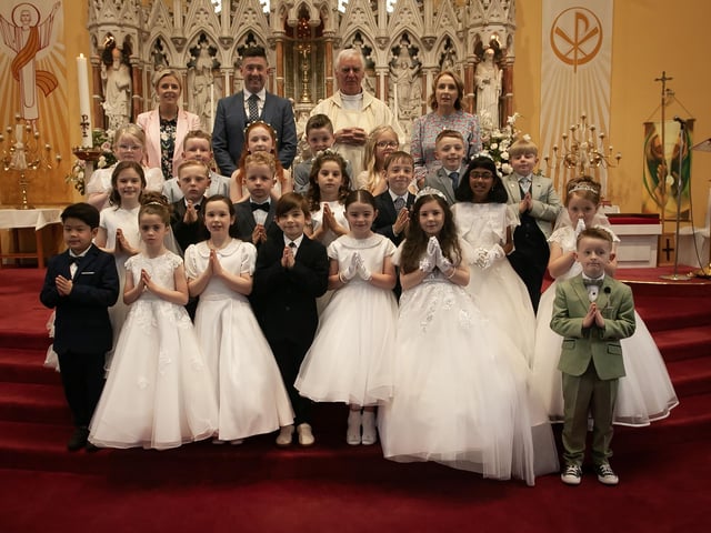 Pupils from Good Shepherd Primary School, Derry who received the Sacrament of First Holy Communion from Fr. Michael Canny at St. Columba's Church, Chapel Road on Friday last. Included at back is Mrs. Suzann McCafferty, Principal, Mr. Brendan Doran, teacher and Mrs. Doran, teacher. (Photo Jim McCafferty Photography)