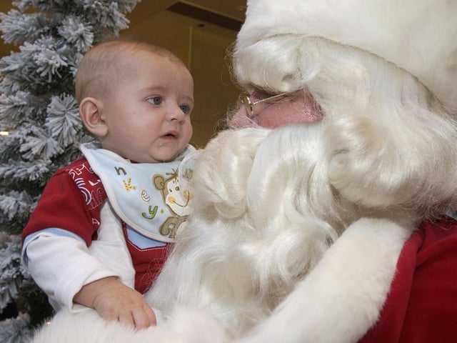 Five months old Riordan McDaid comes face to face with Santa for the first time. (0811PG16) : Santa at Foyleside in 2005.