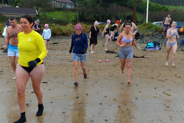 People taking part in the annual ARC Fitness New Year's Day Charity Swim at Lisfannon beach make their way into the Swilly.  Photo: George Sweeney. DER2301GS  03