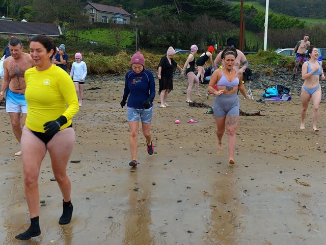 People taking part in the annual ARC Fitness New Year's Day Charity Swim at Lisfannon beach make their way into the Swilly. Photo: George Sweeney. DER2301GS 03