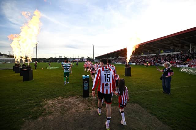 James Clarke of Derry City walks out with a mascot before the SSE Airtricity Men's Premier Division match between Derry City and Shamrock Rovers at Find Insurance Celtic Park in Derry. Photo by Ramsey Cardy/Sportsfile