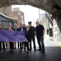 PURPLE FLAG AWARD. . . .Group pictured at the City's Walls in Derry on Wednesday afternoon to celebrate the awarding of an impressive 13th consecutive recognition from the Association of Town and City Management (ATCM). This remarkable achievement reflects the city’s unwavering commitment to providing a diverse range of captivating experiences for residents and visitors alike. From bustling restaurants and thriving bars to captivating cultural events. Derry continues to shine as a beacon of excellence in night-time economy offerings. Included from left are Chief Inspector Luke Moyne PSNI, Darren McPartland Foyle Haven, Ian Crowe HM Lord Lieutenant, Barry Tucker Visit Derry, Tony McDaid Translink, Ceara Quigley City Centre Initiative, Niall Doran Community Safety Warden PCSP, Jim Roddy City Centre Manager, Brian Williamson North West Development Office (DfC), Kieran Thompson Community Safety Warden PCSP, Eileen Best First Housing, John Bannon City Centre NPT, and William Ferguson DCSDC Streetscape. (Photo: Jim McCafferty Photography) : Purple Flag.