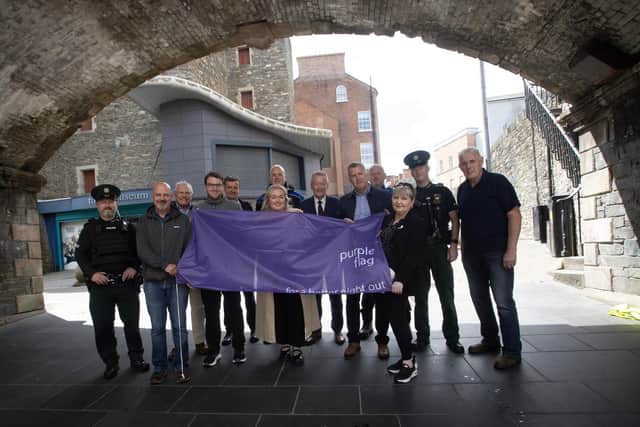 PURPLE FLAG AWARD. . . .Group pictured at the City's Walls in Derry on Wednesday afternoon to celebrate the awarding of an impressive 13th consecutive recognition from the Association of Town and City Management (ATCM). This remarkable achievement reflects the city’s unwavering commitment to providing a diverse range of captivating experiences for residents and visitors alike. From bustling restaurants and thriving bars to captivating cultural events. Derry continues to shine as a beacon of excellence in night-time economy offerings. Included from left are Chief Inspector Luke Moyne PSNI, Darren McPartland Foyle Haven, Ian Crowe HM Lord Lieutenant, Barry Tucker Visit Derry, Tony McDaid Translink, Ceara Quigley City Centre Initiative, Niall Doran Community Safety Warden PCSP, Jim Roddy City Centre Manager, Brian Williamson North West Development Office (DfC), Kieran Thompson Community Safety Warden PCSP, Eileen Best First Housing, John Bannon City Centre NPT, and William Ferguson DCSDC Streetscape. (Photo: Jim McCafferty Photography) : Purple Flag.