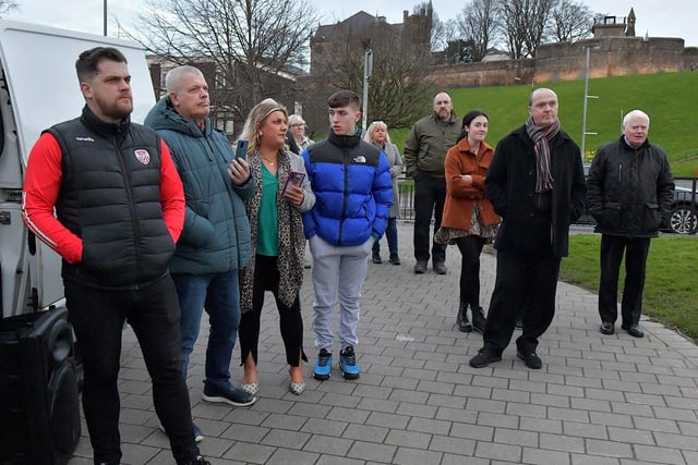 Some of the attendance at the protest against the British government’s controversial Legacy Bill at Free Derry Wall on Monday evening. Organised by the Bloody Sunday Trust and the Pat Finucane Centre images of 269 victims of state violence were projected onto the Bogside’s iconic monument. Photo: George Sweeney. DER2313GS – 02