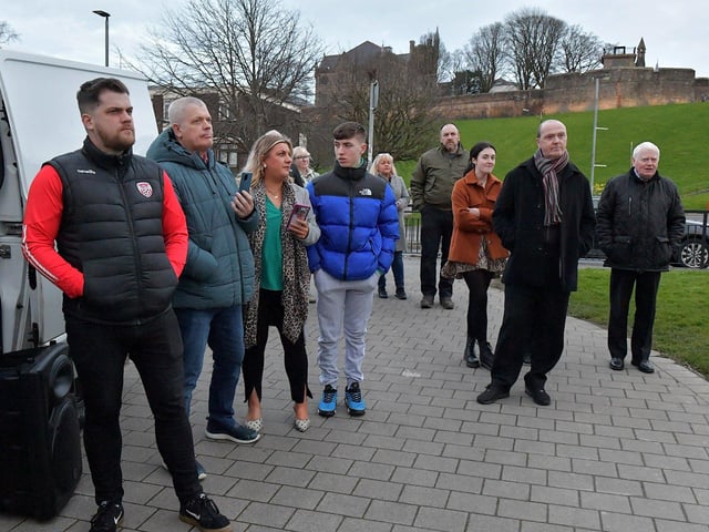 Some of the attendance at the protest against the British government’s controversial Legacy Bill at Free Derry Wall on Monday evening. Organised by the Bloody Sunday Trust and the Pat Finucane Centre images of 269 victims of state violence were projected onto the Bogside’s iconic monument. Photo: George Sweeney. DER2313GS – 02
