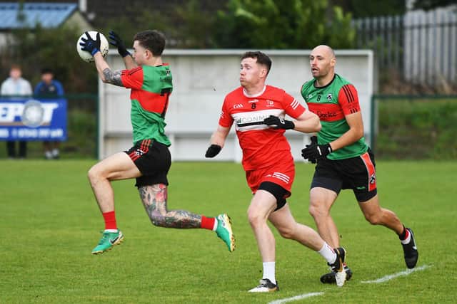 Caelan O'Connell wins the ball for Doire Trasna during their match against Magilligan. (Photo: Keith Moore)