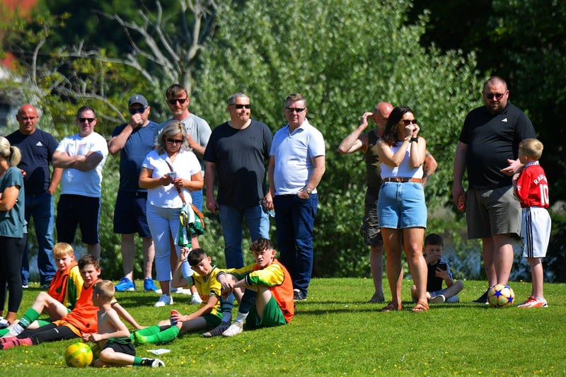Spectators enjoy the sunshine and soccer at the D&D Championship Summer Cup finals at Prehen on Sunday morning last. Photo: George Sweeney. DER2322GS - 51