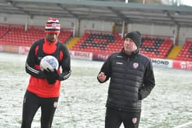 Alan Reynolds, Derry City assistant boss talks to midfielder Sadou Diallo during pre-season training.