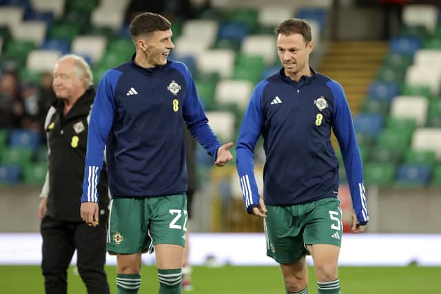 Former Derry City captain Eoin Toal and Jonny Evans during Northern Ireland's warm-up before Tuesday’s UEFA Euro 2024 Qualifier against Slovenia.