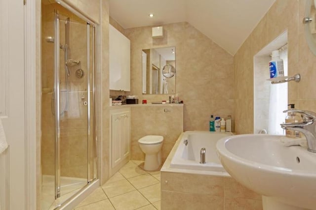 The master bedroom's en-suite includes a bath, shower cubicle, hand basin and wc.