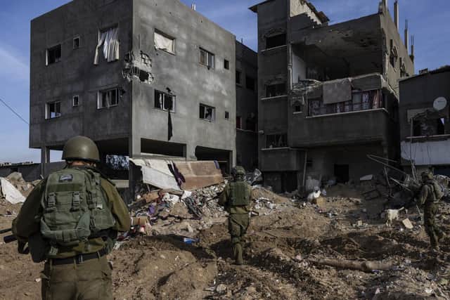 This picture taken during a media tour organised by the Israeli military on January 8, 2024, shows troops operating in the area of al-Bureij in the central Gaza Strip, amid continuing battles between Israel and the Palestinian militant group Hamas. (Photo by Menahem KAHANA / AFP) (Photo by MENAHEM KAHANA/AFP via Getty Images)