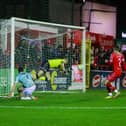 Michael Duffy guides his equalising goal past Conor Kearns. Photo by Kevin Moore.