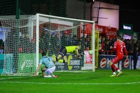 Michael Duffy guides his equalising goal past Conor Kearns. Photo by Kevin Moore.