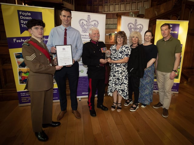 Group pictured at the Foyle Down Syndrome Trust's handing over of the King's Award for Voluntary Service at the Guildhall last week. From left, Sgt. Niall Downey, Irish Guards, Christopher Cooper, manager, FDST, Vice Lord Lieutenant Ian Moore, MBE, Angela Thompson, chair.   The Vice Lord Lieutenant Alan Moore, OBE, presenting the King's Award for Voluntary Service certificate to Benjamin Thompson in the Guildhall on Friday last. At back is Sgt. Niall Downey, Irish Guards (Photos: Jim McCafferty Photography)