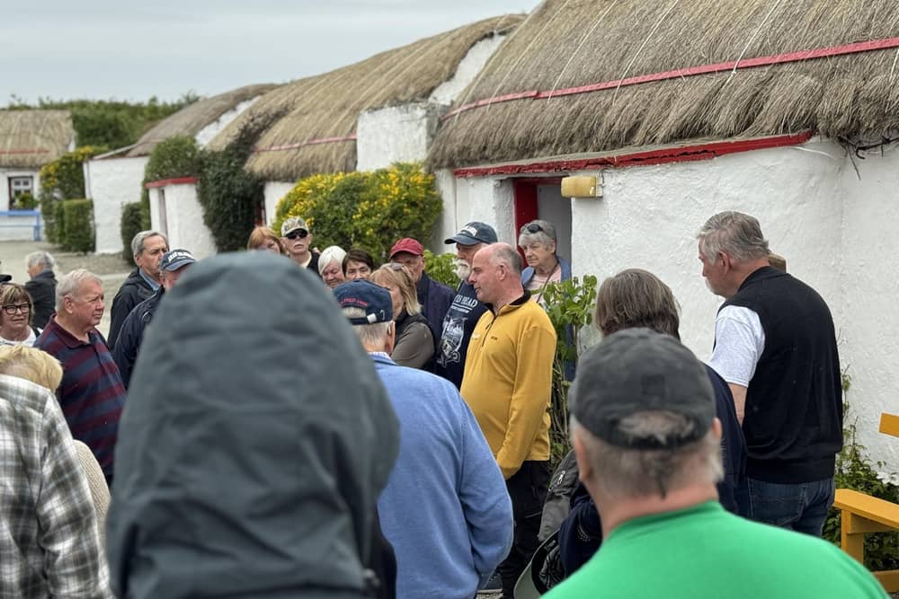 Pat Doherty leading a tour through the village.