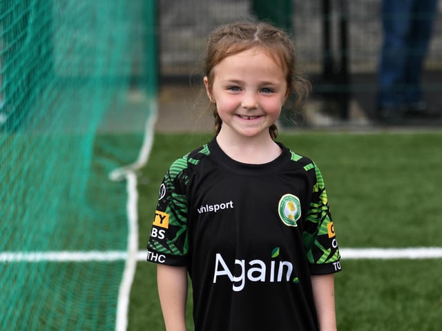 This young fan smiles for the camera at the Waterside Shared Village.