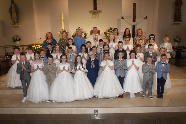 Children from St. John’s Primary School, Derry pictured after receiving the Sacrament of First Holy Communion from Fr. Daniel McFaul at St Mary’s Church, Creggan on Sunday morning. Included back from left are Mrs. Geraldine O’Connor, Principal, Mrs. Deborah Cunningham, Ms Donna Toland, Mrs. Feena McGowan, teacher, Miss Sarah Dooley and Mrs. Rachel Doherty. (Photos: Jim McCafferty Photography)