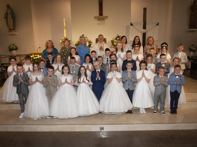 Children from St. John’s Primary School, Derry pictured after receiving the Sacrament of First Holy Communion from Fr. Daniel McFaul at St Mary’s Church, Creggan on Sunday morning. Included back from left are Mrs. Geraldine O’Connor, Principal, Mrs. Deborah Cunningham, Ms Donna Toland, Mrs. Feena McGowan, teacher, Miss Sarah Dooley and Mrs. Rachel Doherty. (Photos: Jim McCafferty Photography)