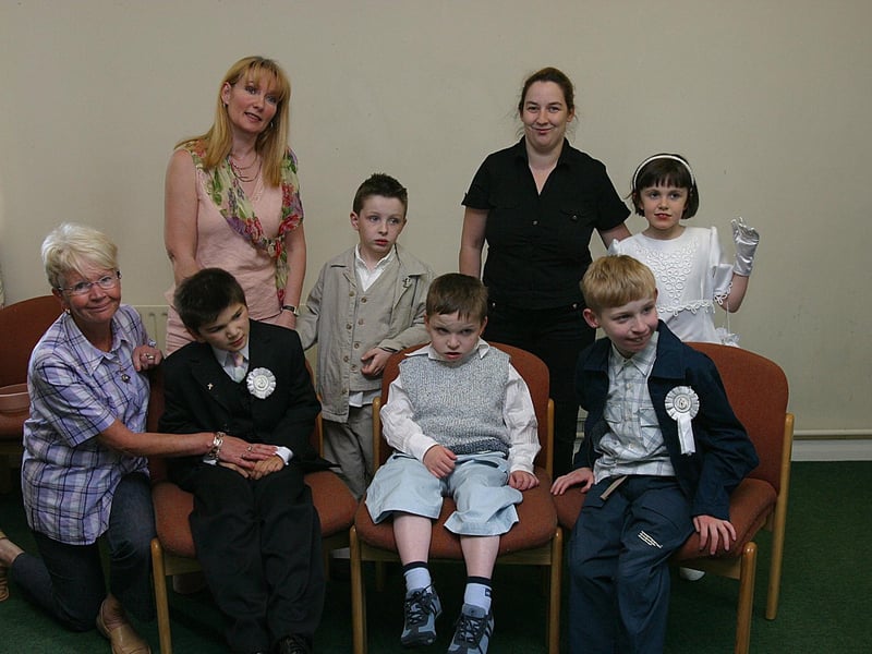 Pupils at Foyle View School, who made their first Holy Communion at Pennyburn Chapel. From left (front row) are Margaret O"Reilly, classroom assistant, pupils Gareth Rodgers, Matthew Brown and Glenn McCarthy. Standing, Martina McComish, teacher, Fearghal Duffy, Bridgeen Stevenson, teacher, and Leanna McGonigle. (0606T09)