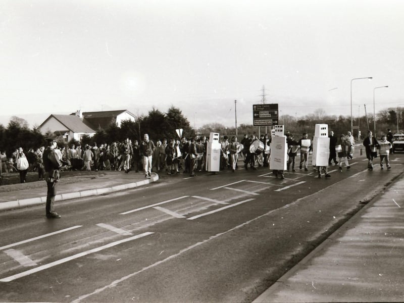An armed RUC officer faces protesters on Buncrana Road at a Faulty Towers cross-border protest over checkpoints and security force towers in 1993.
