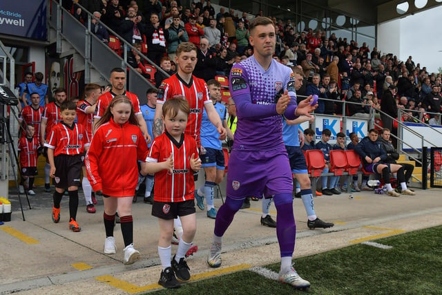 Derry City players and mascots make their way onto the pitch on Friday evening last. Photo: George Sweeney.  DER2320GS – 136