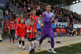 Derry City goalkeeper Brian Maher leads out the teams with mascots on Friday evening last. Photo: George Sweeney.  DER2320GS – 136