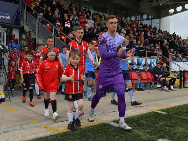 Derry City goalkeeper Brian Maher leads out the teams with mascots on Friday evening last. Photo: George Sweeney.  DER2320GS – 136