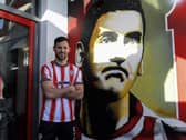 New City striker Pat Hoban pictured beside the Mark Farren mural at Brandywell. Photo: George Sweeney