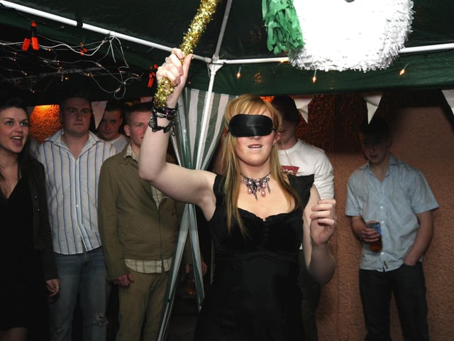 Party in full swing as Clare Morrison hits the snowman Pinada and party guests look on, 0019JML. : Parties across Derry in January 2006.