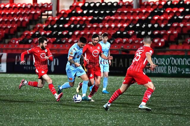 Loughgall players converge on Institute's Rhys McDermott.  Photograph: George Sweeney