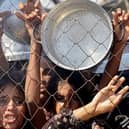 Palestinians, mostly children, push to receive a hot meal at a charity kitchen in the Mawasi area of Khan Yunis in the southern Gaza Strip on July 22, 2025. The head of Gaza's largest hospital said 21 children have died due to malnutrition and starvation in the Palestinian territory in the past three days, amid a devastating assault by Israeli forces. (Photo by AFP) (Photo by -/AFP via Getty Images)