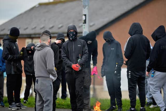 Masked youths with petrol bombs in Creggan on Monday afternoon. Photo: George Sweeney