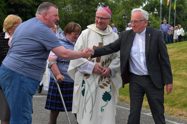 Fr Con McLaughlin PP is greeted by a parishioner after Mass, at the Church of the Sacred Heart, Carndonagh, on Saturday evening, to mark the occasion of his Golden Jubilee in the priesthood.  Photo: George Sweeney. DER2323GS – 166