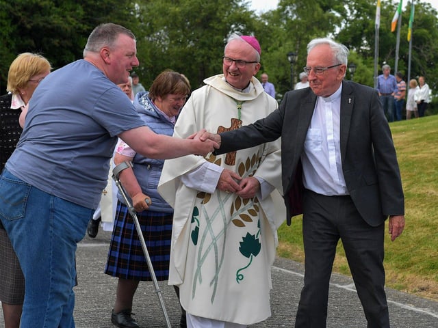 Fr Con McLaughlin PP is greeted by a parishioner after Mass, at the Church of the Sacred Heart, Carndonagh, on Saturday evening, to mark the occasion of his Golden Jubilee in the priesthood. Photo: George Sweeney. DER2323GS – 166
