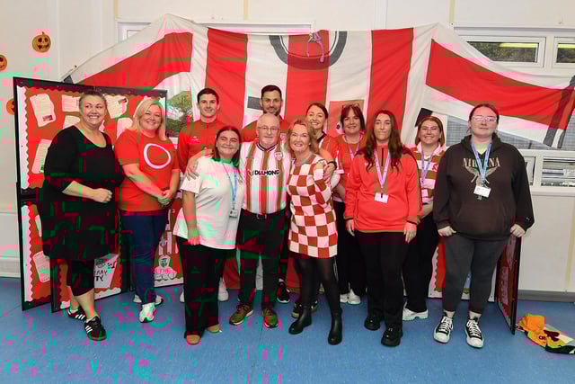 Staff from Gaelscoil Eadain Mhoir, pictured with Derry City’s Ciaran Coll and Pat Hoban during their visit to the school on Monday morning.  Photo: George Sweeney